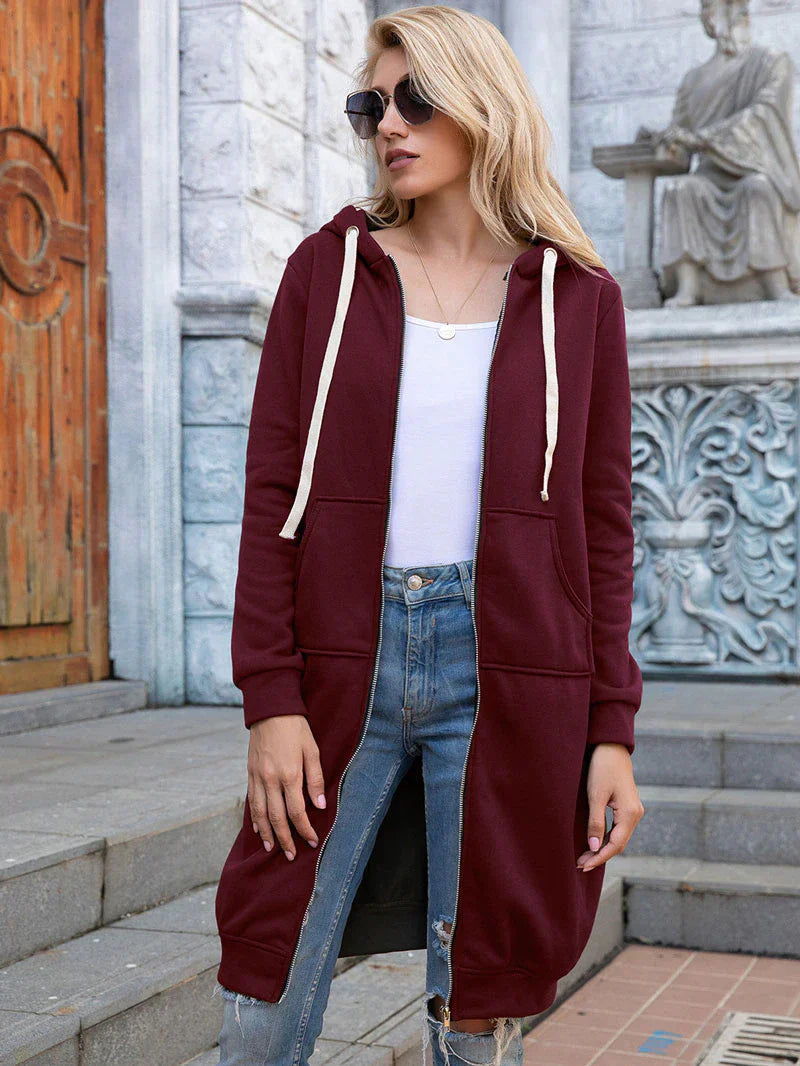 Women's longline zip hoodie with drawstring hood, midweight fabric, extended length, cozy style for cooler seasons.