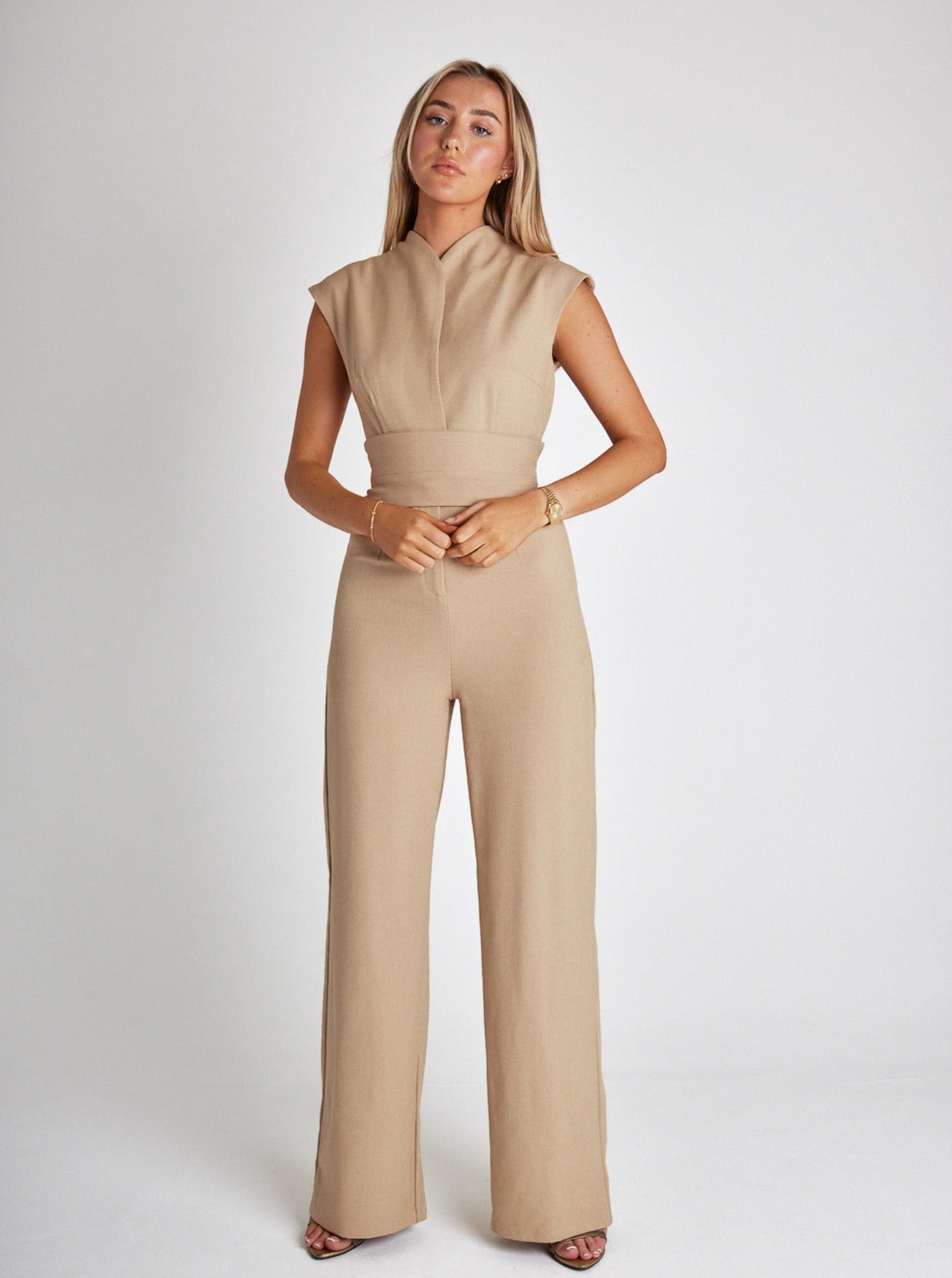 "Women's sleeveless belted jumpsuit with wide-leg, soft fabric, and detachable belt for stylish and comfortable wear."