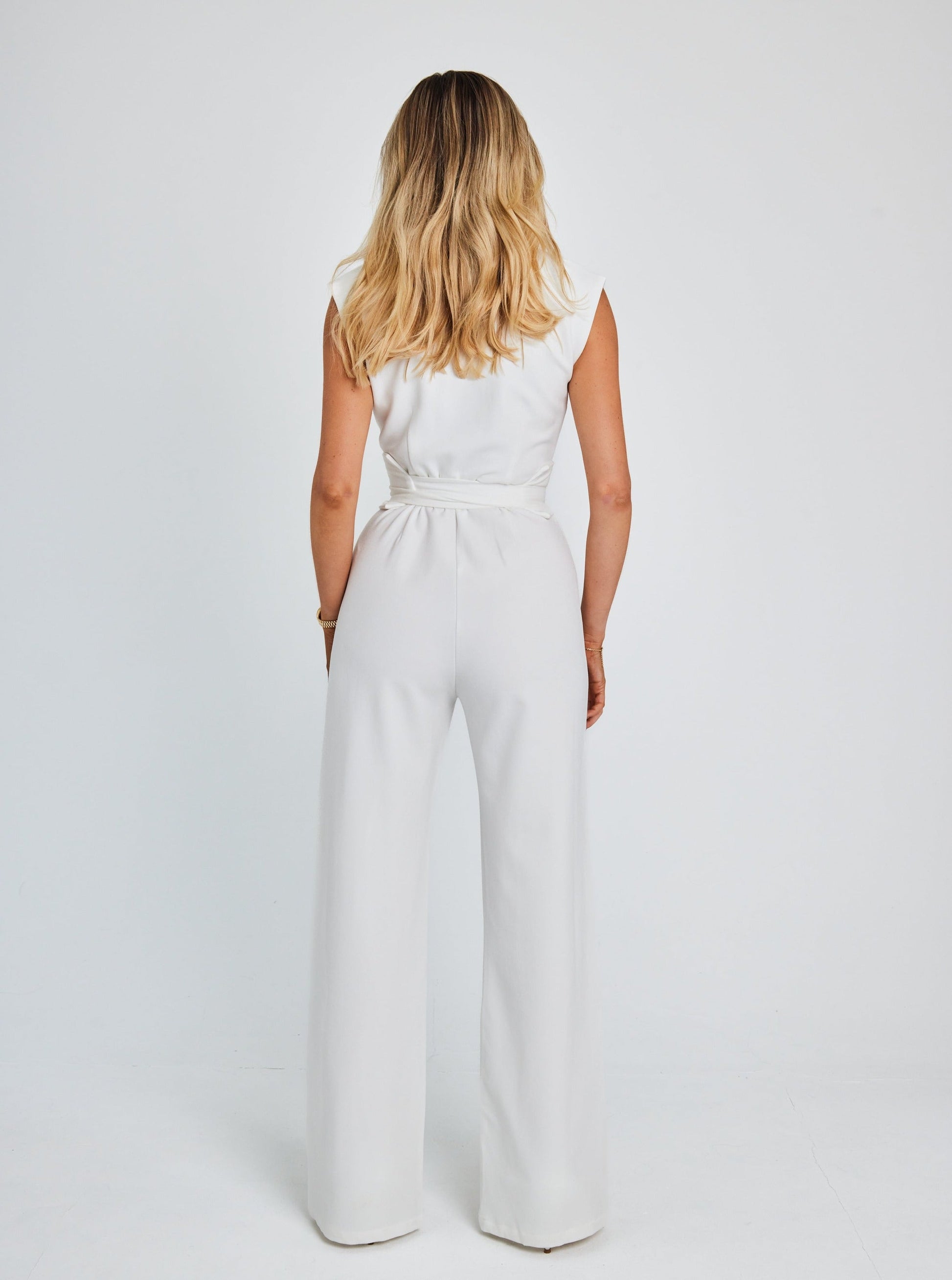 "Women's sleeveless belted jumpsuit with wide-leg, soft fabric, and detachable belt for stylish and comfortable wear."