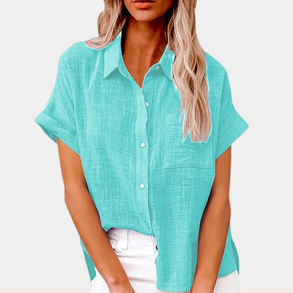 "Women's summer blouse with button-down front and classic collar, relaxed fit in light blue, front view."