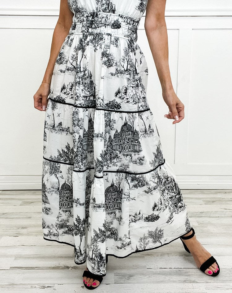 Women's toile print maxi dress with puff sleeves, showcases vintage charm with a scenic motif and fitted silhouette.