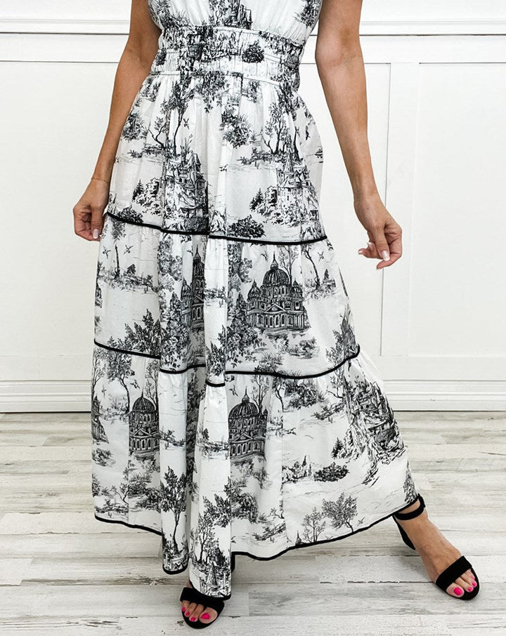 Women's toile print maxi dress with puff sleeves, showcases vintage charm with a scenic motif and fitted silhouette.