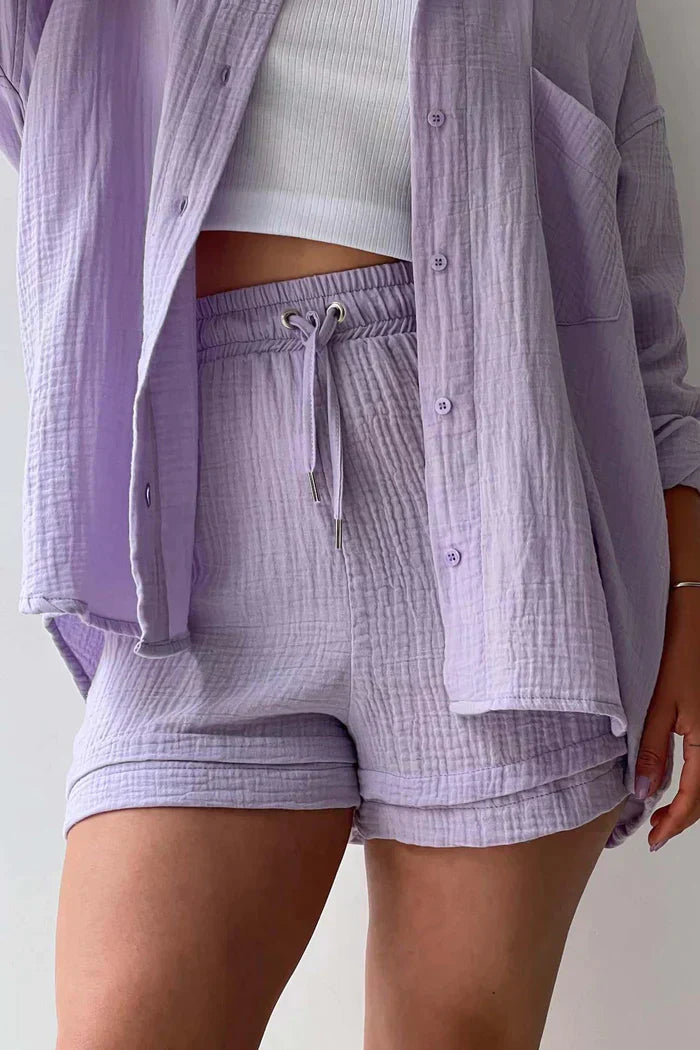 Women's vibrant summer lounge set featuring a button-up shirt and high-waist shorts in a bold, casual style.