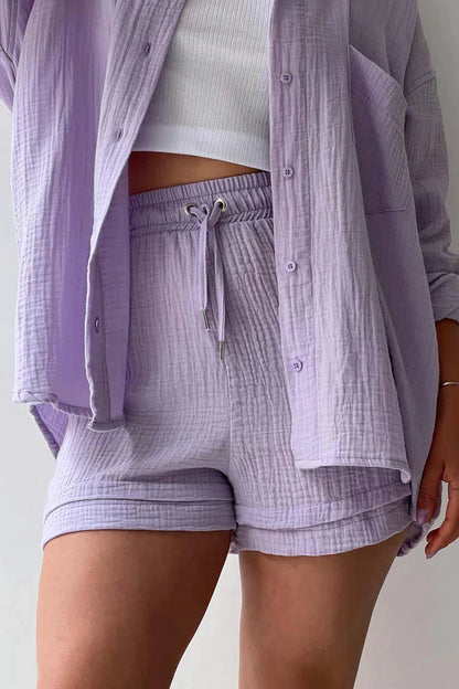 Women's vibrant summer lounge set featuring a button-up shirt and high-waist shorts in a bold, casual style.