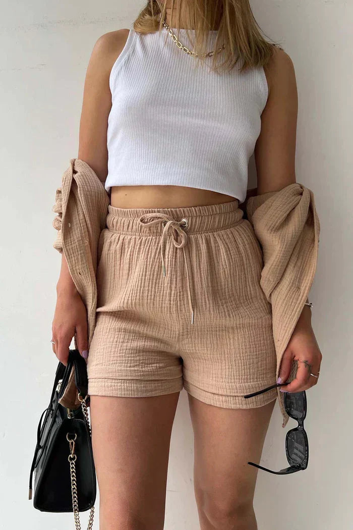 Women's vibrant summer lounge set featuring a button-up shirt and high-waist shorts in a bold, casual style.