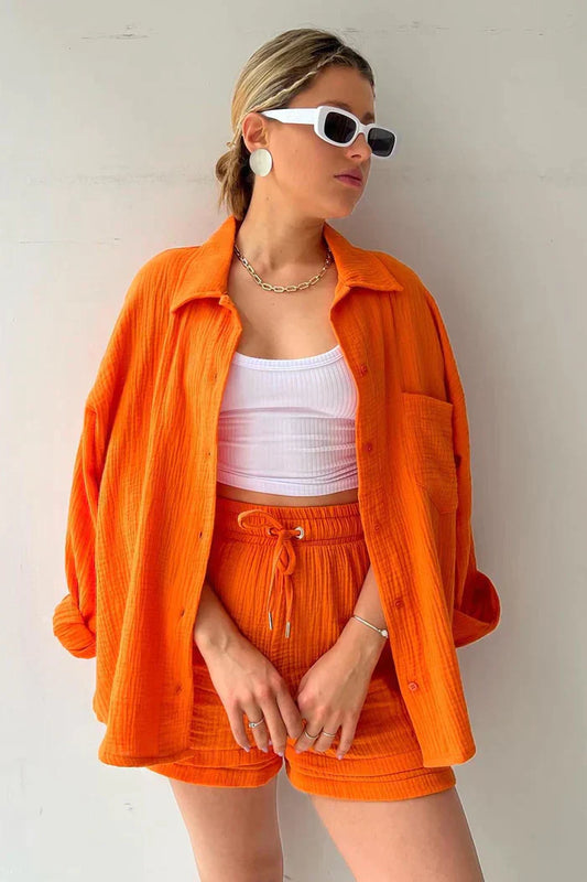 Women's vibrant summer lounge set featuring a button-up shirt and high-waist shorts in a bold, casual style.